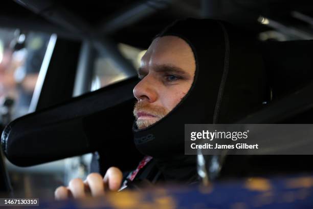 Conor Daly, driver of the BitNile.com Chevrolet, sits in his car in the garage area during practice for the NASCAR Cup Series 65th Annual Daytona 500...