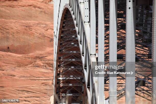 metal arch bridge spanning rock canyon - glen canyon dam stock pictures, royalty-free photos & images