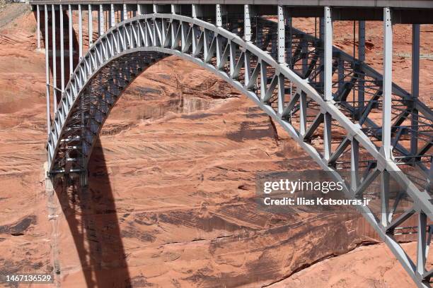 metal arch bridge spanning rock canyon - glen canyon dam stock pictures, royalty-free photos & images