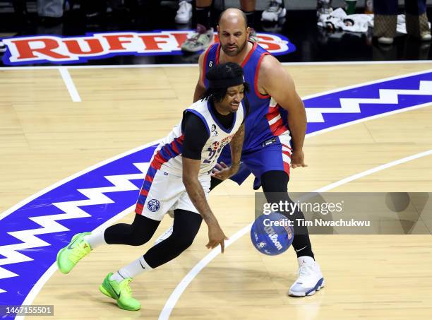 Rapper 21 Savage of Team Dwayne dribbles against baseball player Albert Pujols of Team Ryan during the first quarter in the 2023 NBA All Star Ruffles...