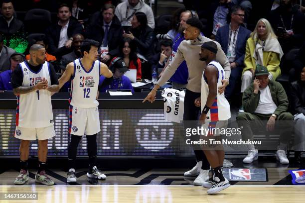 Coach Giannis Antetokounmpo of Team Dwayne talks with tennis player Frances Tiafoe of Team Dwayne during the first quarter in the 2023 NBA All Star...