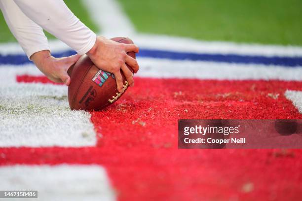 James Winchester of the Kansas City Chiefs snaps the ball during warmups against the Philadelphia Eagles after Super Bowl LVII at State Farm Stadium...