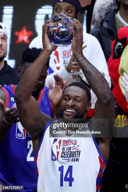 Football player DK Metcalf of Team Dwayne hoist the MVP trophy after the 2023 NBA All Star Ruffles Celebrity Game at Vivint Arena on February 17,...