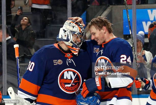 Scott Mayfield and Ilya Sorokin of the New York Islanders celebrate their 5-4 victory over the Pittsburgh Penguins at UBS Arena on February 17, 2023...