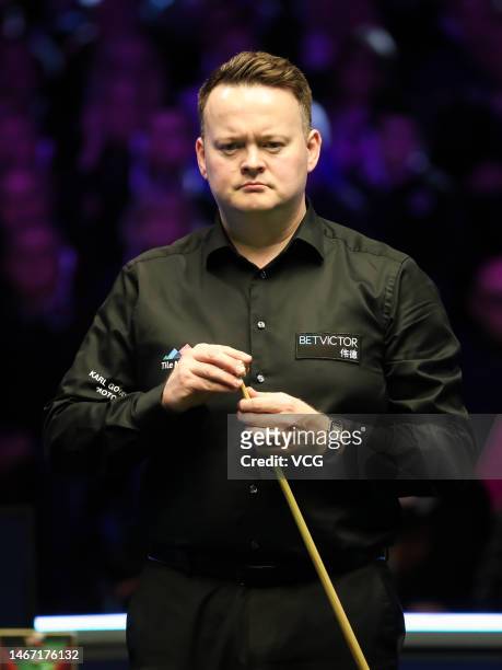 Shaun Murphy of England chalks the cue in the quarterfinal match against Yuan Sijun of China on day five of 2023 Betvictor Welsh Open at Venue Cymru...