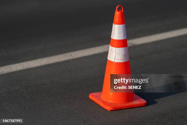 traffic cone,an image of cautions on asphalt road - kegel stock-fotos und bilder
