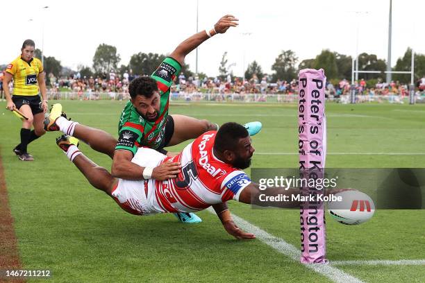 Alex Johnston of the Rabbitohs tackles Mikaele Ravalawa of the Dragons to stop him scorin g a try during the NRL Trial and Charity Shield match...