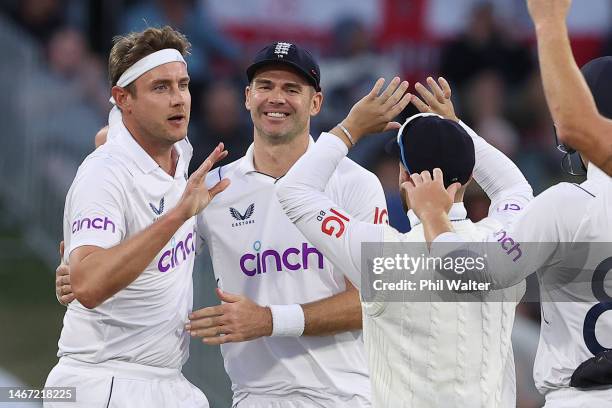 Stuart Broad of England celebrates bowling Devon Conway of New Zealand with James Anderson during day three of the First Test match in the series...