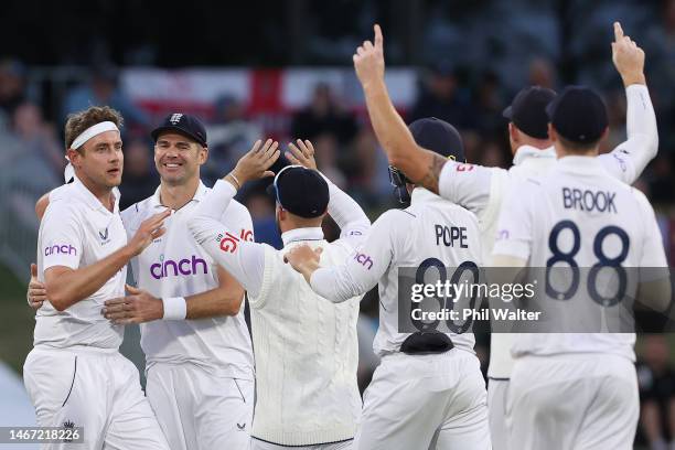 Stuart Broad of England celebrates bowling Devon Conway of New Zealand with James Anderson during day three of the First Test match in the series...