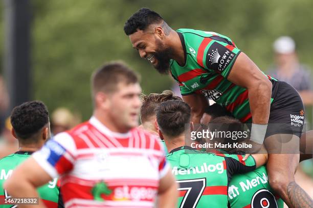 Cody Walker of the Rabbitohs celebrates with his team mates after scoring a try during the warm-up before the NRL Trial and Charity Shield match...