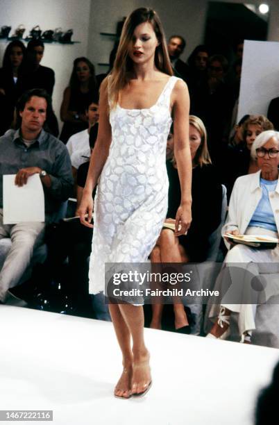 Model Kate Moss presents a voided velvet foliate patterned slip dress while editor Polly Mellen watches. The resort collection is presented to an...