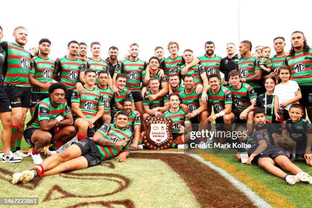 The Rabbitohs pose with the Charity Shield as they celebrate victory during the NRL Trial and Charity Shield match between St George Illawarra...