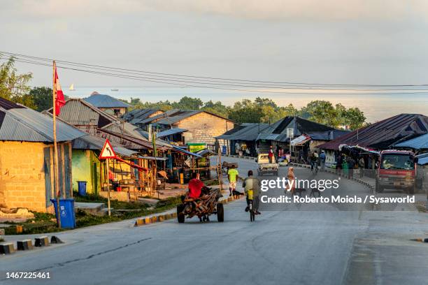 people on the road in a rural village, tanzania - tanzania stock pictures, royalty-free photos & images