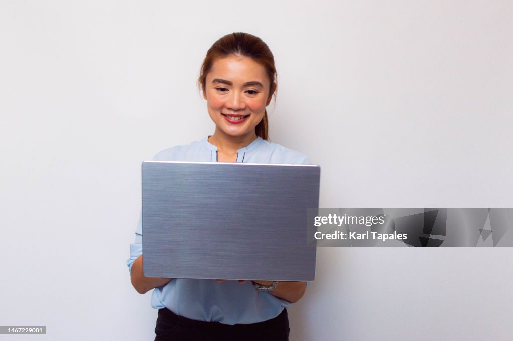 A Southeast Asian Woman Is Using A Laptop On A White Background High ...