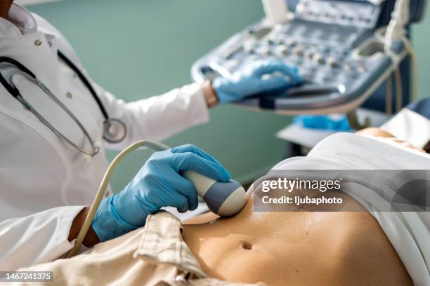 doctor examining woman with ultrasound - pancreatic cancer stockfoto's en -beelden