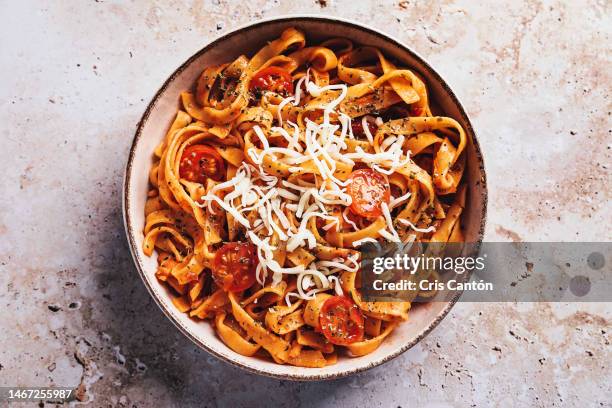 tagliatelle with tomato sauce on stone background - spaghetti stock-fotos und bilder