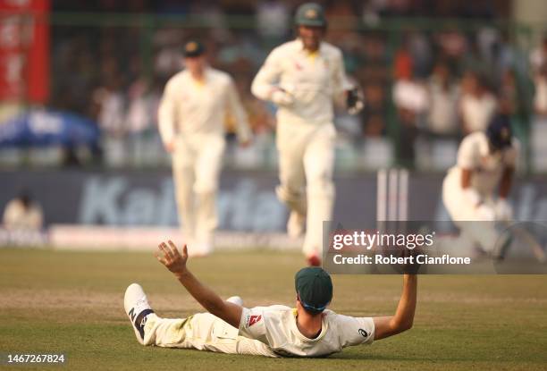 Pat Cummins of Australia celebrates taking a catch to dismiss Axar Patel of India during day two of the Second Test match in the series between India...