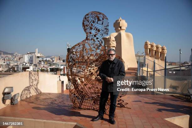Sculptor Jaume Plensa poses next to his sculpture 'Poesia del silencio', after being installed on the roof of Casa Mila, on 18 February, 2023 in...