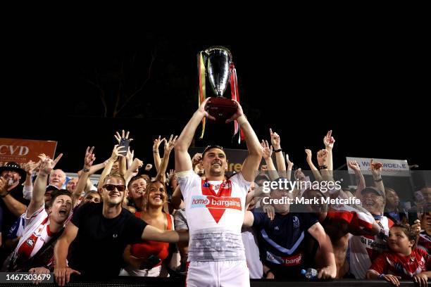 Lewis Dodd of the Saints holds aloft the World Club Challenge trophy with fans after victory during the World Club Challenge and NRL Trial Match...