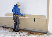 Carpenter installing siding