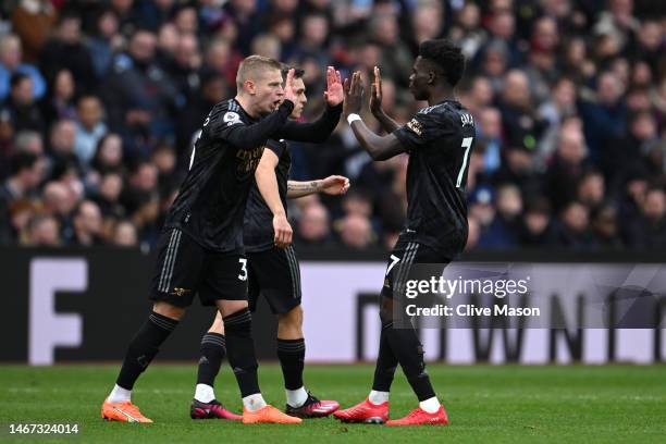 Oleksandr Zinchenko celebrates with Bukayo Saka of Arsenal after scoring the team's second goal during the Premier League match between Aston Villa...