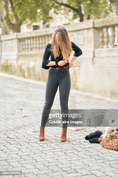 portrait of a young girl getting her clothes done on a street - down blouse ストックフォトと画像