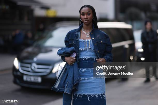 Fashion week guest seen wearing a denim look with a cropped jeans jacket, a jeans dress and blue boots before the Mark Fast show during London...
