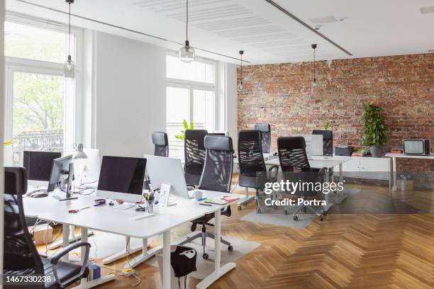 creative office interior with hardwood floor - empty desk stock pictures, royalty-free photos & images