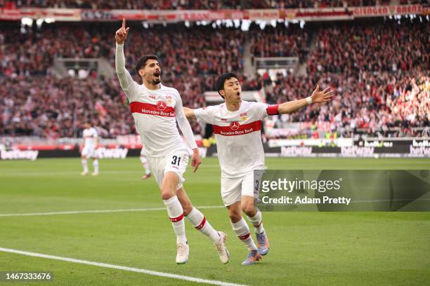 Gil Dias of VfB Stuttgart celebrates with teammate Wataru Endo after scoring the team's first goal during the Bundesliga match between VfB Stuttgart...