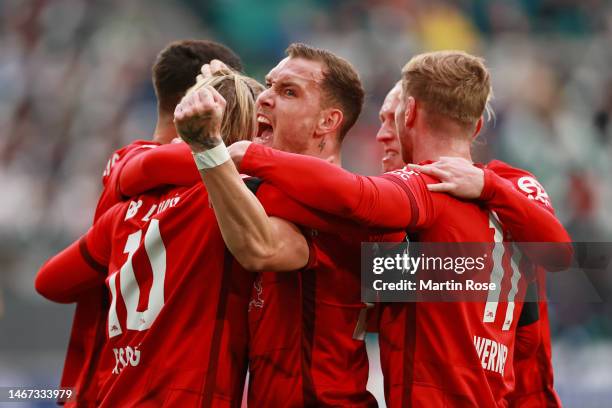 Emil Forsberg of RB Leipzig celebrates with teammates after scoring the team's first goal during the Bundesliga match between VfL Wolfsburg and RB...