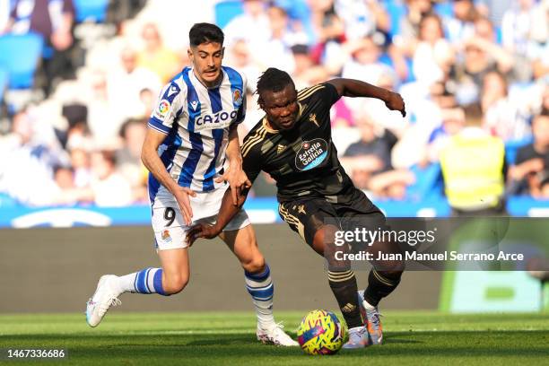 Joseph Aidoo of RC Celta battles for possession with Carlos Fernandez of Real Sociedad during the LaLiga Santander match between Real Sociedad and RC...
