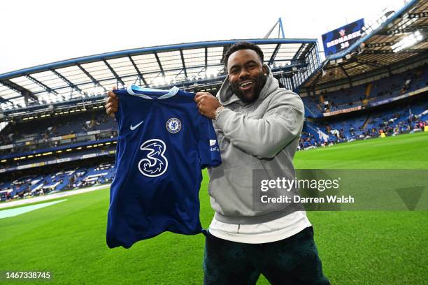 Mark Ingram II, NFL American Football Player for the New Orleans Saints, poses for a photograph with a Chelsea shirt prior to the Premier League...