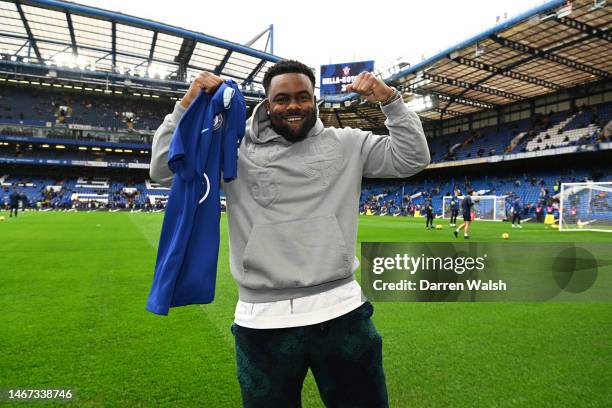 Mark Ingram II, NFL American Football Player for the New Orleans Saints, poses for a photograph with a Chelsea shirt prior to the Premier League...