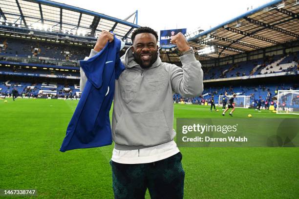 Mark Ingram II, NFL American Football Player for the New Orleans Saints, poses for a photograph with a Chelsea shirt prior to the Premier League...