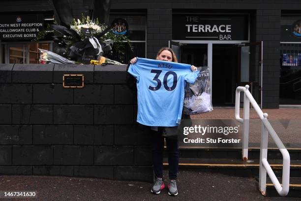 Fan is seen with a shirt of former Premier League player Christian Atsu, who was recovered from the rubble of his home in Hatay following the Turkey...