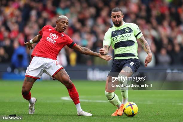 Kyle Walker of Manchester City is challenged by Danilo of Nottingham Forest during the Premier League match between Nottingham Forest and Manchester...