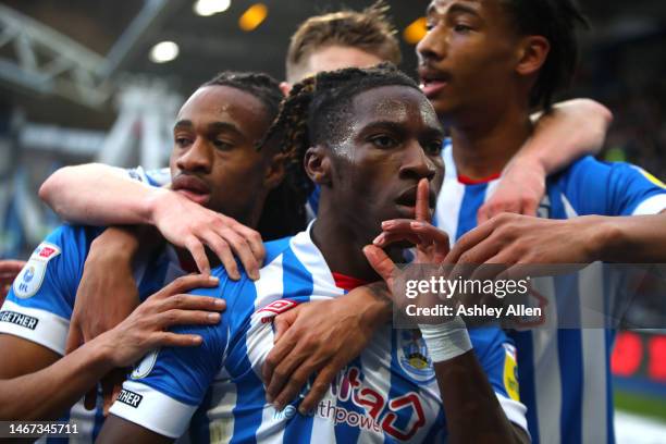 Joseph Hungbo of Huddersfield Town celebrates with teammates after scoring his team's first goal during the Sky Bet Championship between Huddersfield...