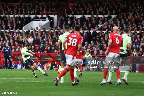 Bernardo Silva of Manchester City scores the team's first goal during the Premier League match between Nottingham Forest and Manchester City at City...