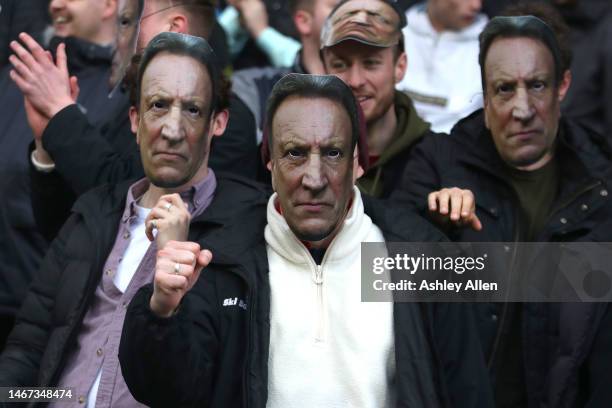 Fans wearing Neil Warnock masks celebrate as Huddersfield Town score during the Sky Bet Championship between Huddersfield Town and Birmingham City at...