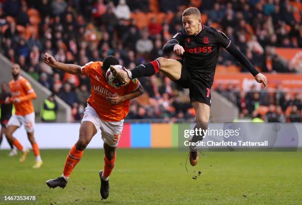 Curtis Nelson of Blackpool is challenged by Dwight Gayle of Stoke City during the Sky Bet Championship between Blackpool and Stoke City at Bloomfield...