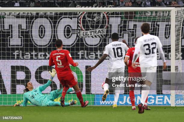 Marcus Thuram of Borussia Moenchengladbach scores the team's third goal past Yann Sommer of FC Bayern Munich during the Bundesliga match between...