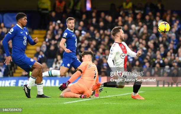 Adam Armstrong of Southampton has a shot which is saved by Kepa Arrizabalaga of Chelsea during the Premier League match between Chelsea FC and...