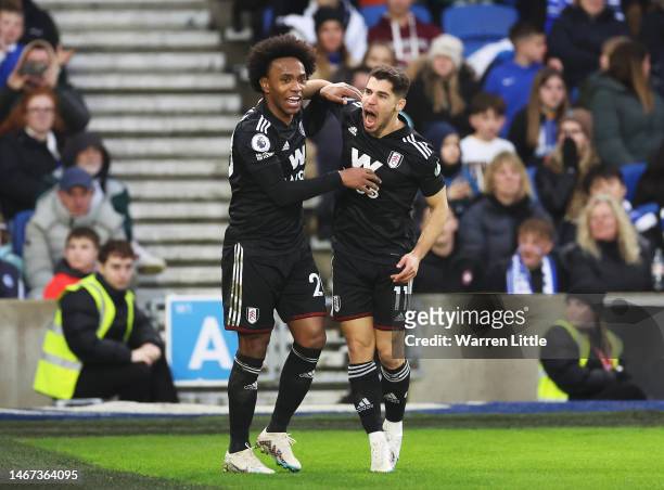 Manor Solomon of Fulham celebrates with teammate Willian after scoring the team's first goal during the Premier League match between Brighton & Hove...