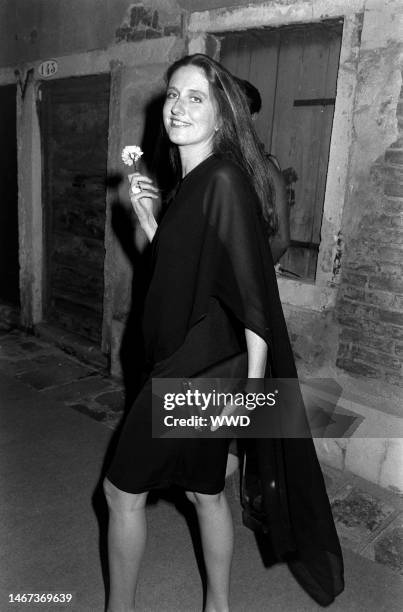 Marie Brandolini AKA Countess Marie Brandolini d'Adda di Valmareno holds flower given by attendants during dinner party after 'Made in Milan' film...