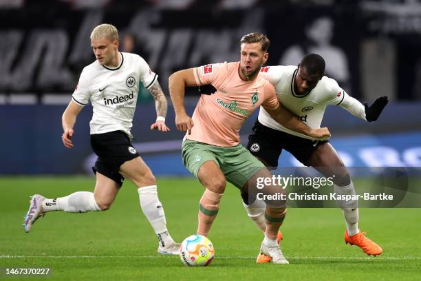 Niclas Fuellkrug of SV Werder Bremen is challenged by Evan Ndicka of Eintracht Frankfurt during the Bundesliga match between Eintracht Frankfurt and...