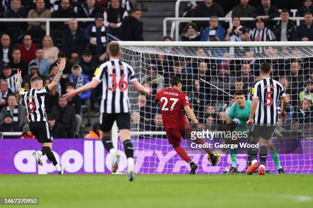 Darwin Nunez of Liverpool scores the team's first goal past Nick Pope of Newcastle United during the Premier League match between Newcastle United...