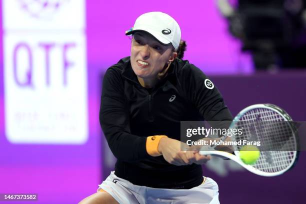 Iga Swiatek of Poland returns the ball to Jessica Pegula of USA during their women's singles final match on day six of the Qatar Total Energies Open,...