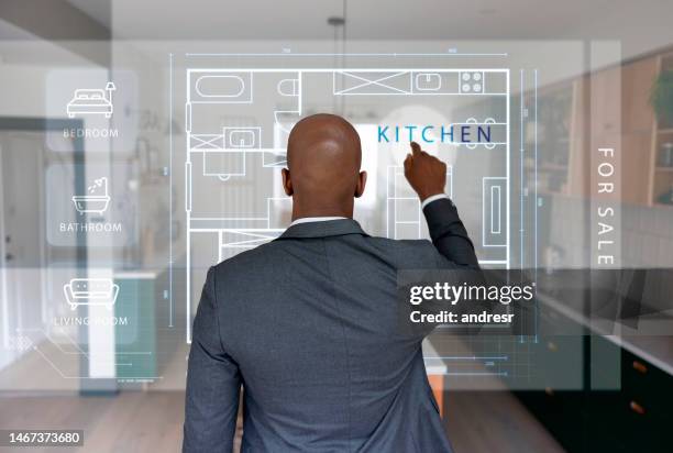 real estate agent looking at a house blueprint using a touch screen - looking from rear of vehicle point of view stock pictures, royalty-free photos & images