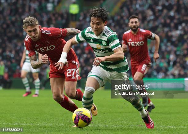 Hyeongyu Oh of Celtic vies with Angus MacDonald of Aberdeen during the Cinch Scottish Premiership match between Celtic FC and Aberdeen FC at on...