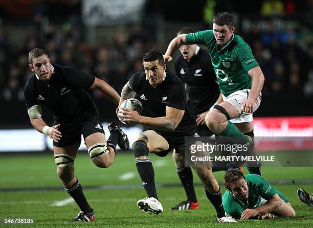 Sonny Bill Williams of New Zealand runs out of a tackle by Eoin Reddan of Ireland during their third and final rugby union Test match at Waikato...
